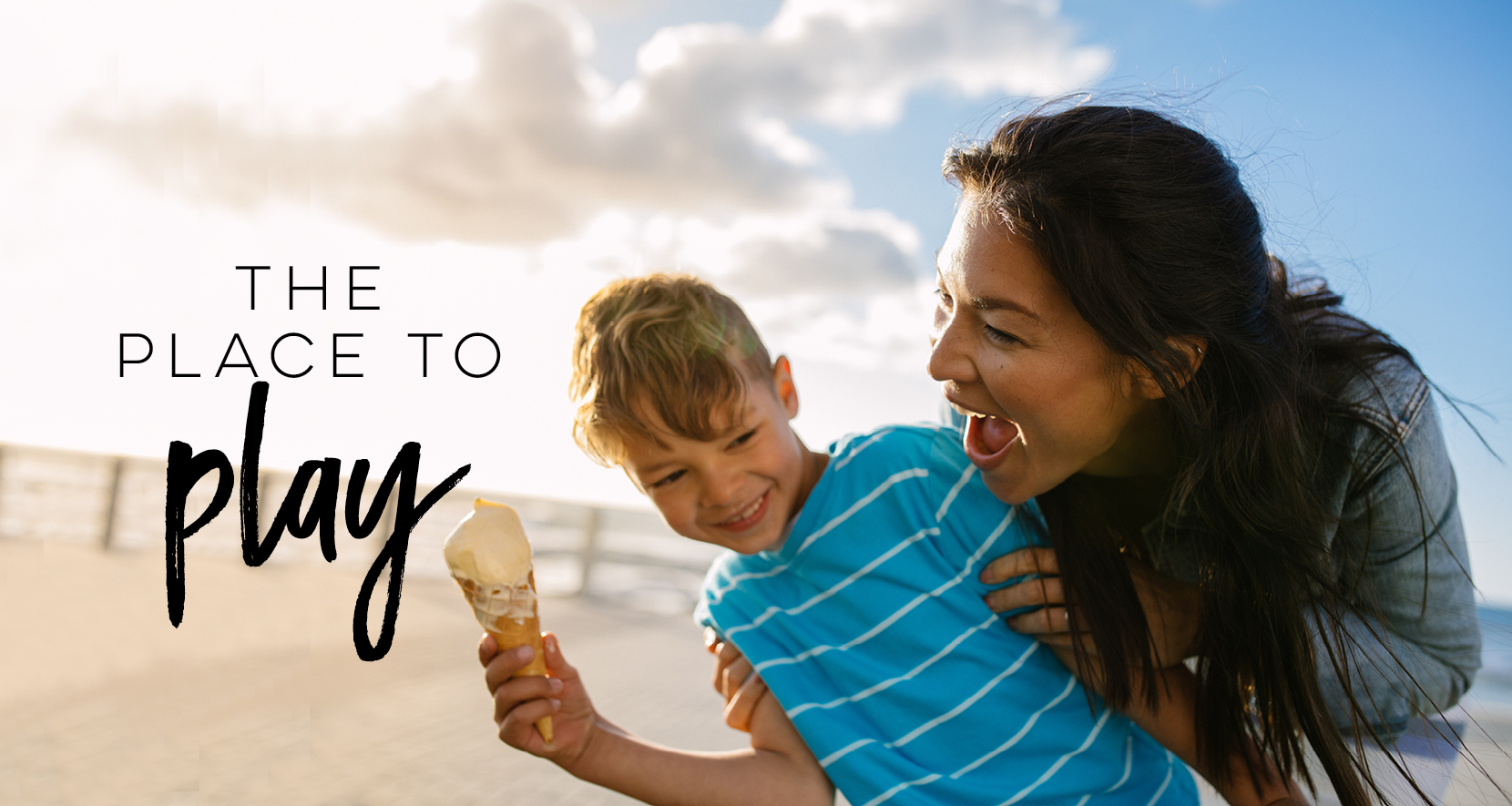 The Place to Play woman and child laughing on beach with an ice cream cone